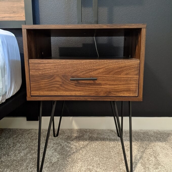 a reviewer&#x27;s brown midcentury modern nightstand which has black hairpin legs