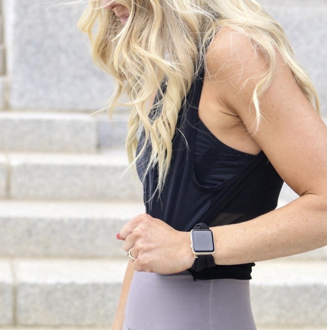 A person wearing a smartwatch and yoga band in black