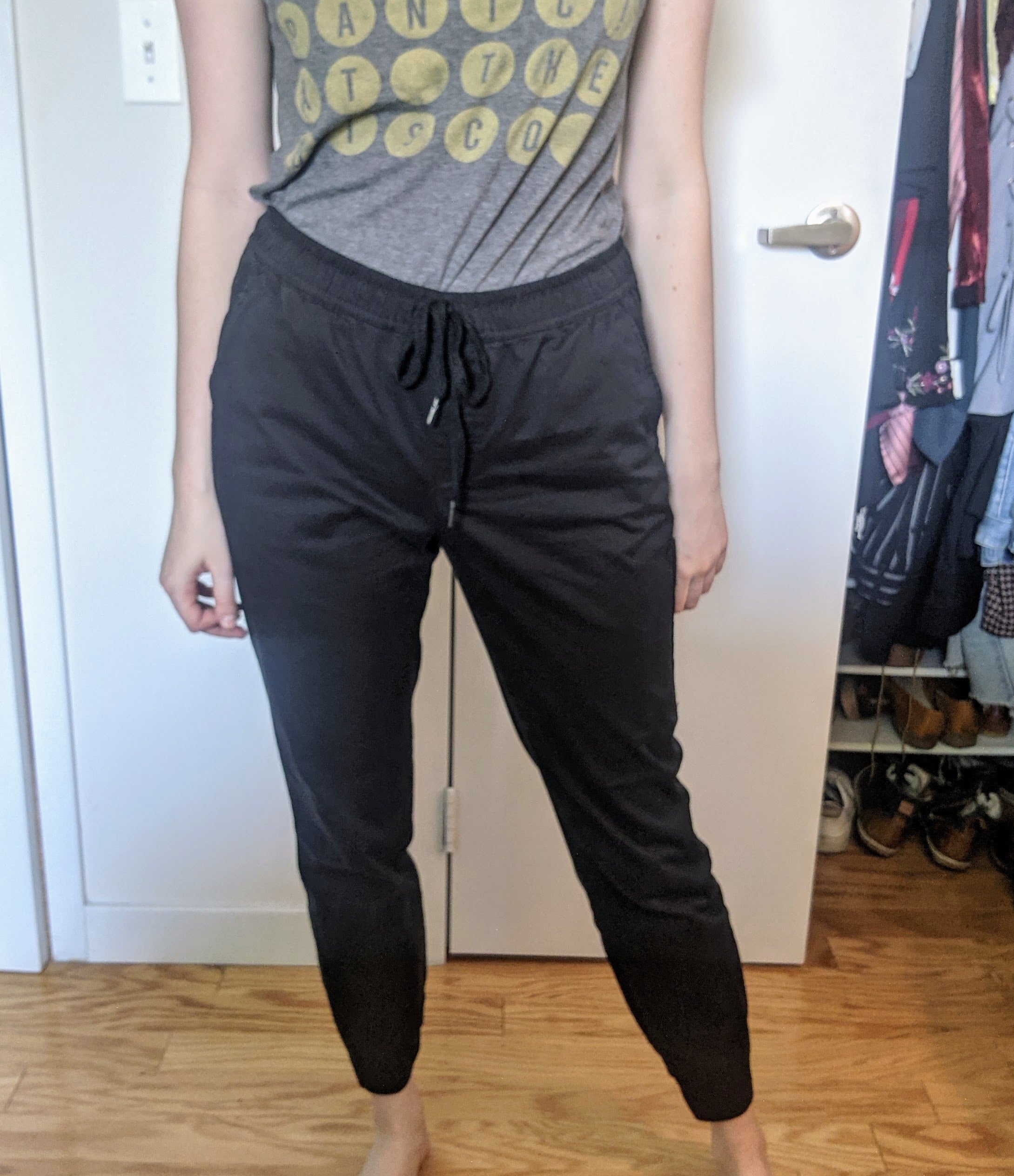 a reviewer wearing the joggers in black on the waist with a T-shirt tucked in 