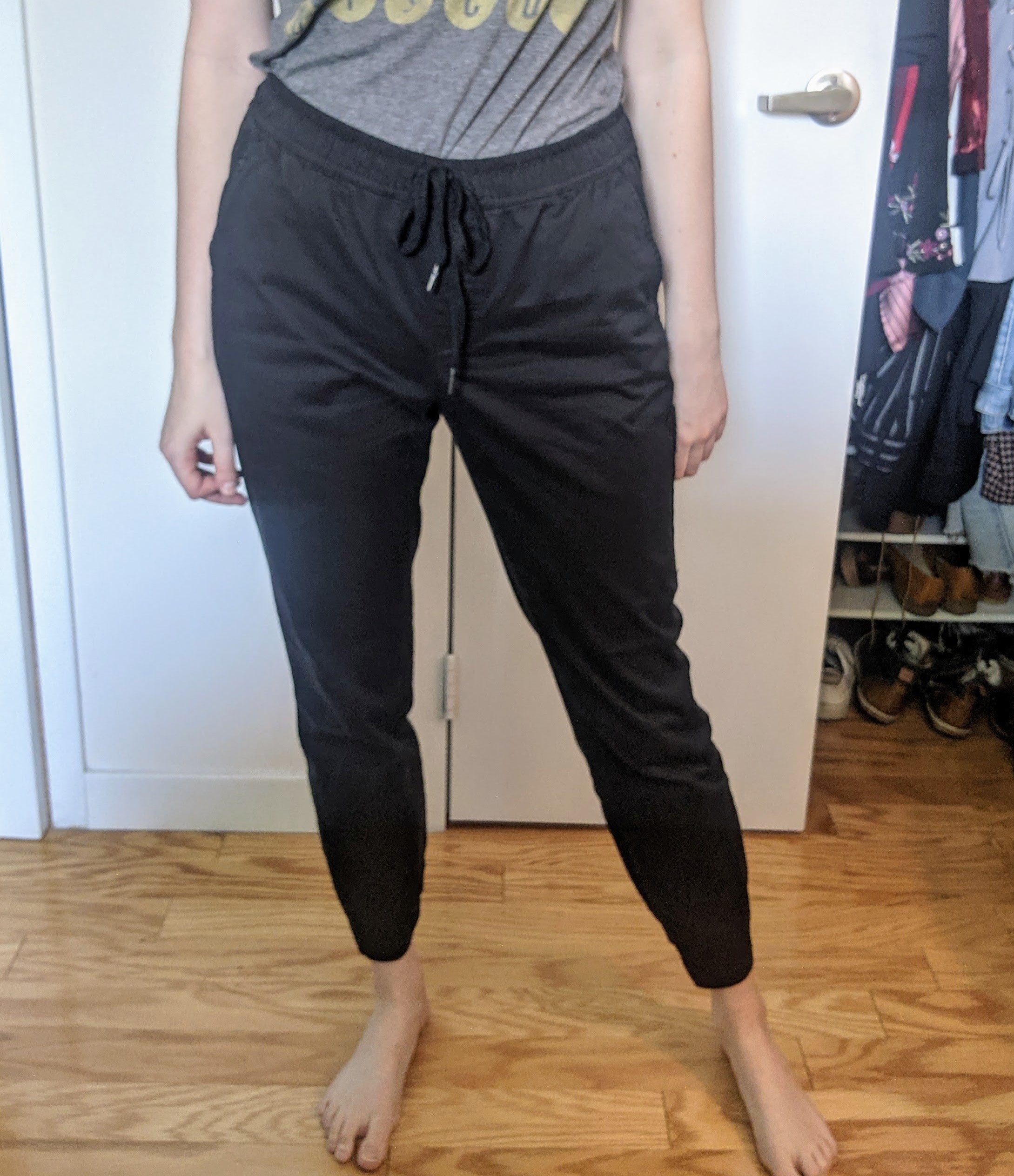 a reviewer wearing the joggers in black on the waist with a T-shirt tucked in 