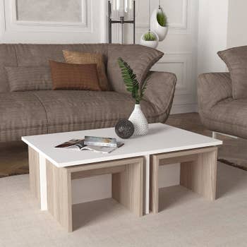 the white coffee table with four birch end tables stored underneath