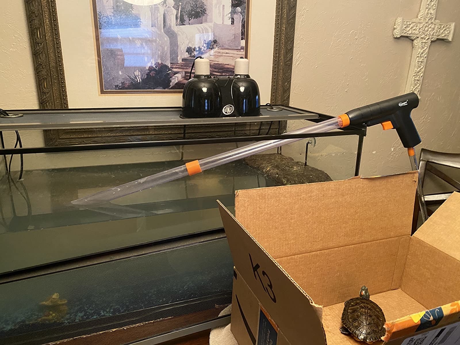 long tube with trigger handle that sucks water and gunk out of aquarium 