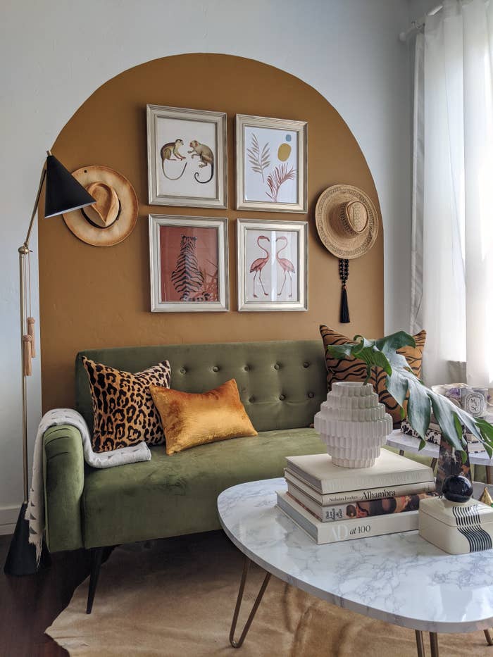 olive green couch styled with pillows in a boho-style living room
