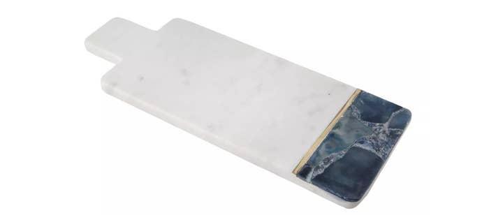 A white marble serving tray with blue agate gemstone and brass inlay