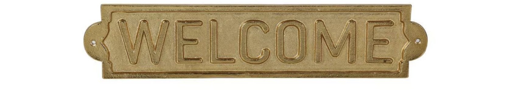 A gold metal sign that says &quot;WELCOME&quot; 