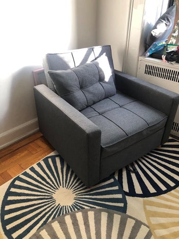 a reviewer's gray chair with a matching pillow