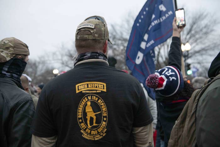 A view of the back of someone's T-shirt, which reads "Oath Keepers: Guardians of the Republic / Not on Our Watch"