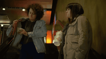 Ilana and Abbi from &quot;Broad City&quot; sneaking tons of snacks into a movie
