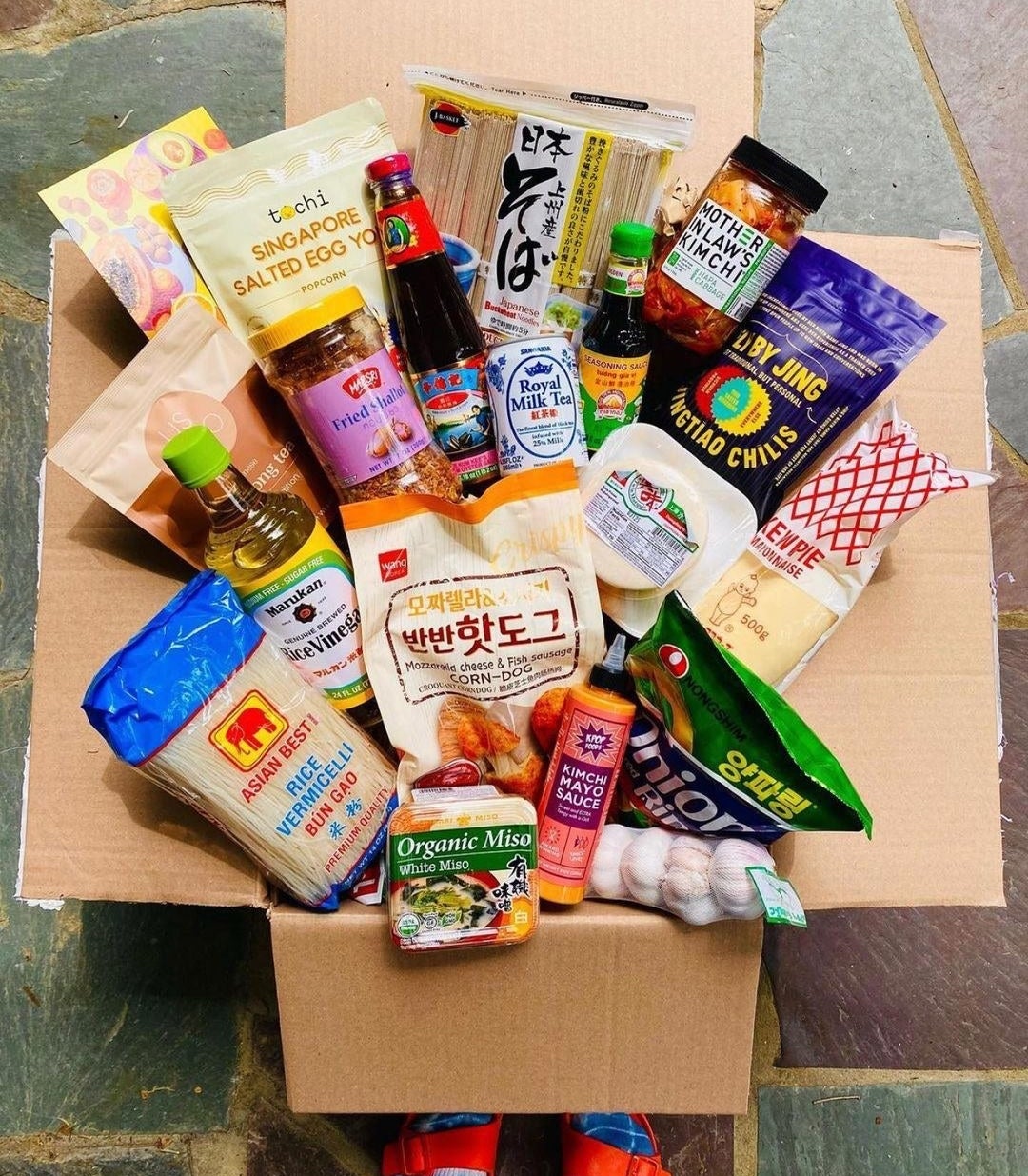 an open box filled with different Asian groceries 