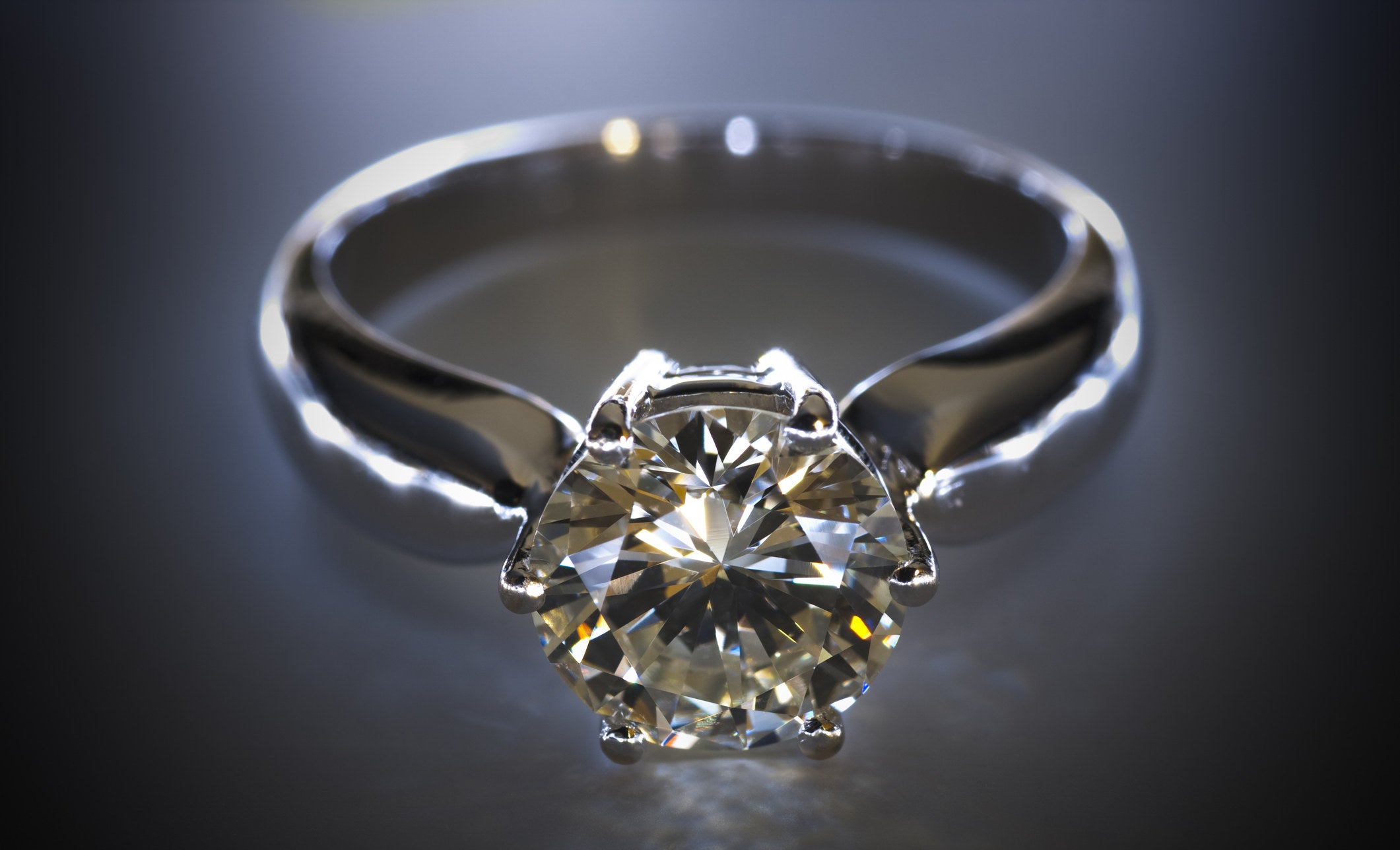 Diamond ring on black table top