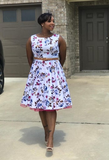 Same reviewer wearing white and purple floral version of dress