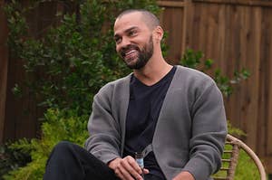 Jesse Williams sits back with a beer in Grey's Anatomy