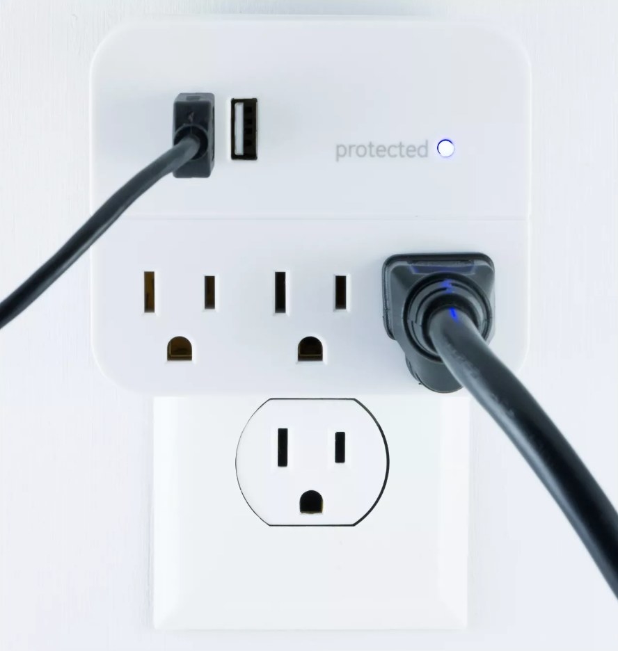 The surge protector with black cable connected and black plug plugged in