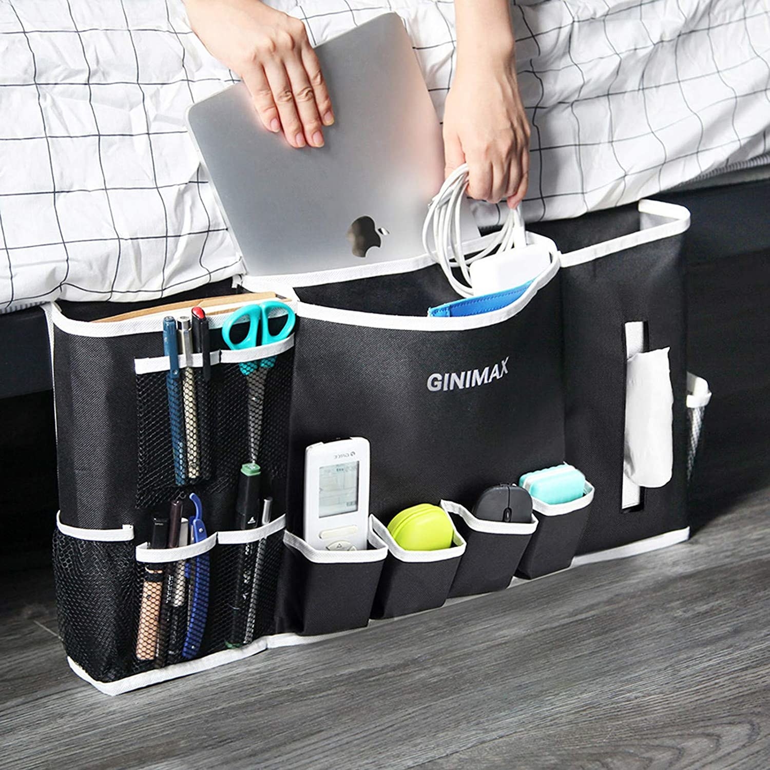 A person putting their laptop into the already-stuffed caddy