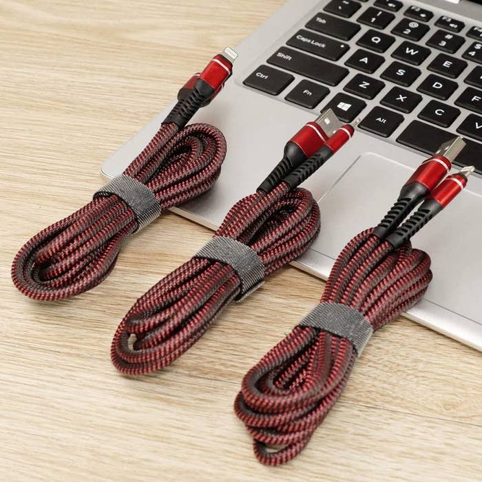 Three cords resting on a laptop