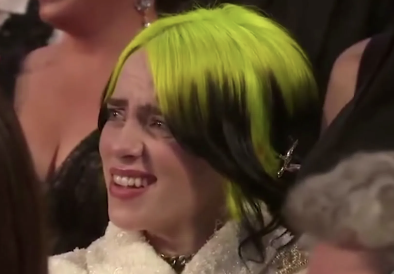 Billie at an awards show with her hair dyed green and black