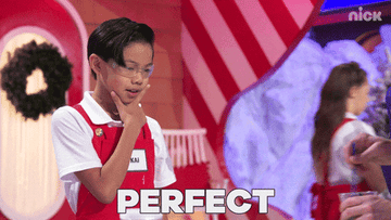a child looking over a bowl and exclaiming &quot;perfect&quot;