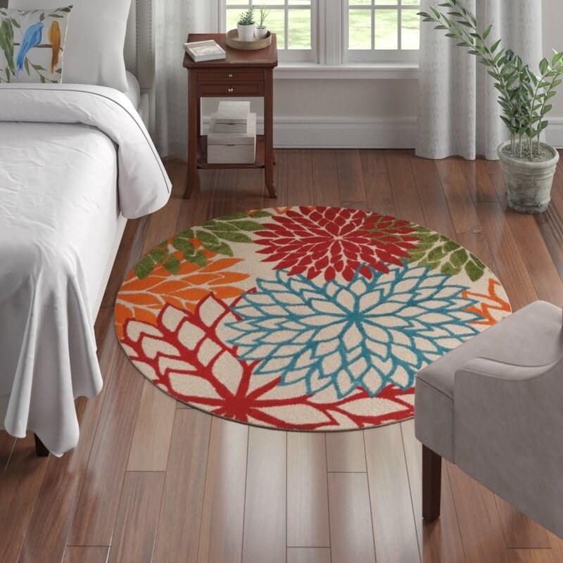 Rug with red, blue, orange, and green flowers