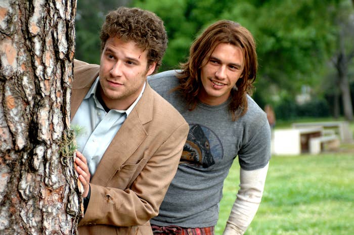 Rogen and Franco look from behind a tree in Pineapple Express