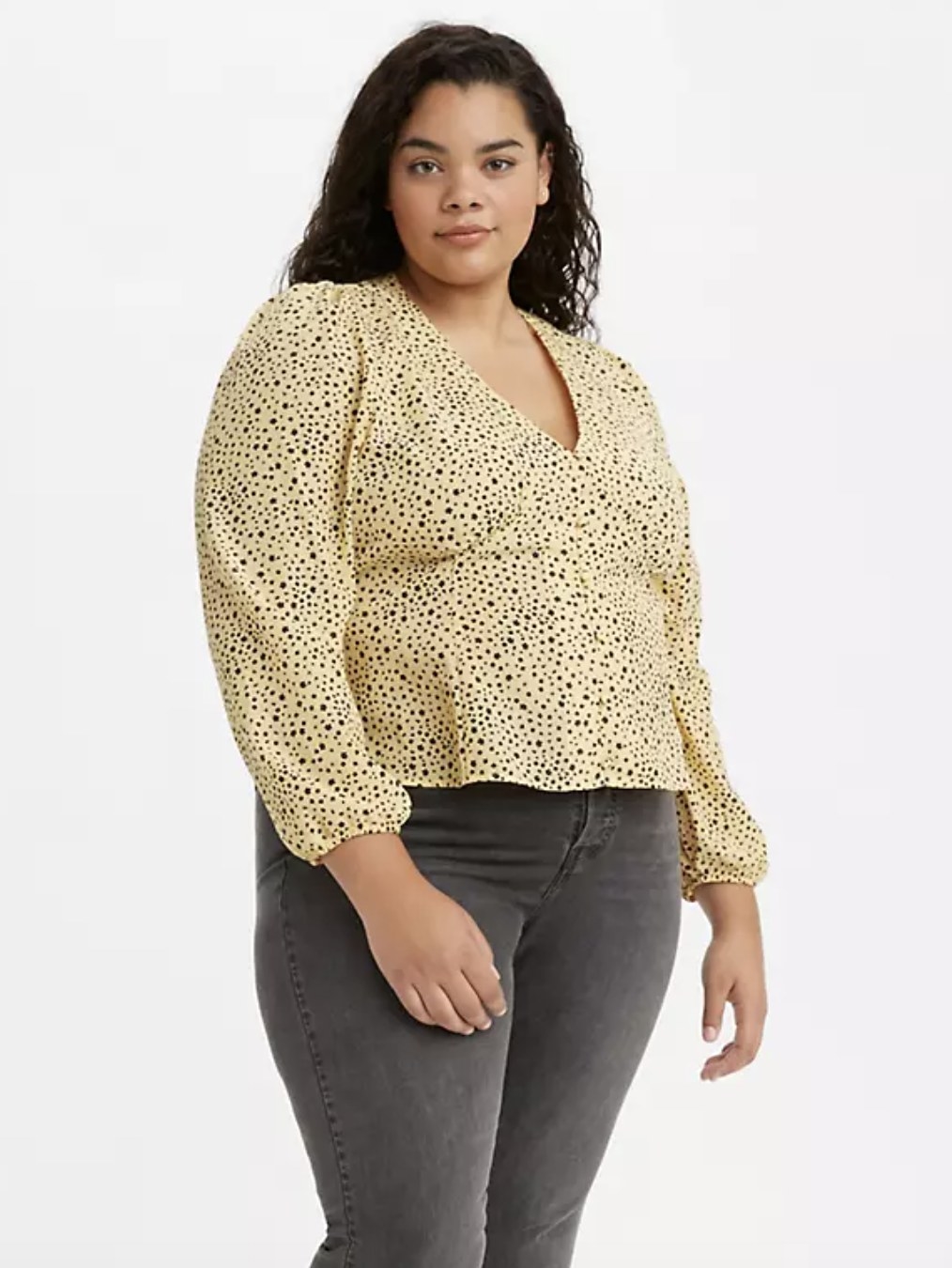 model wearing the top in yellow with black polka dots 