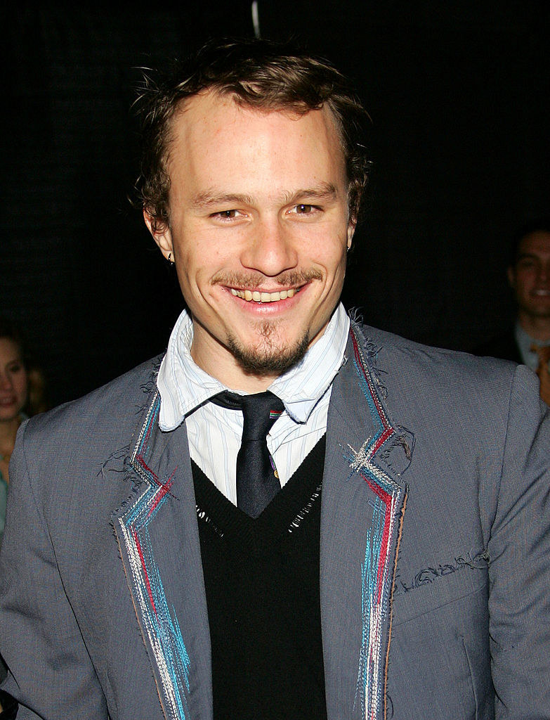 Heath Ledger attends a screening of a film; he is wearing a suit and smiling 