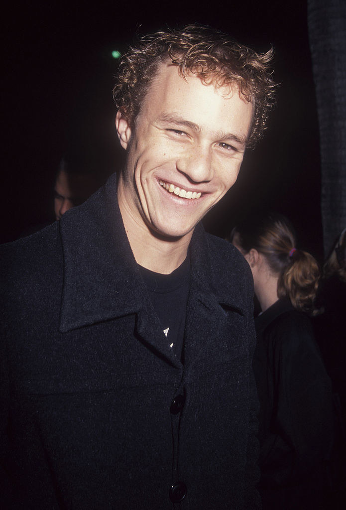 Heath ledger at a red carpet event smiling at the camera