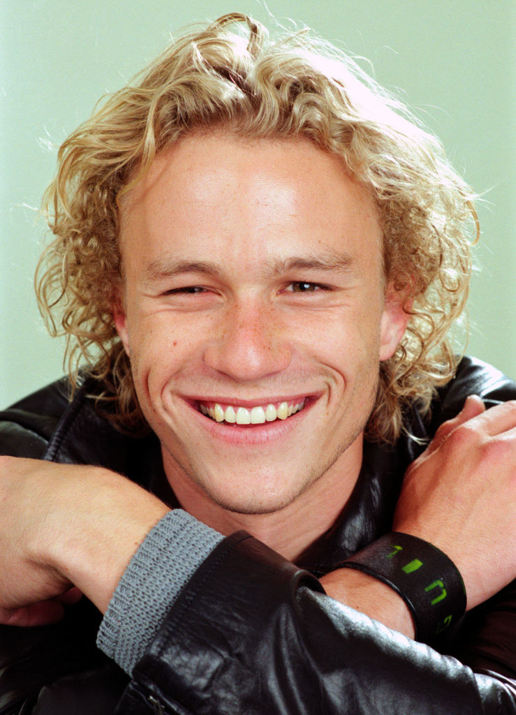 Heath Ledger during a photoshoot; the photo is a closeup with Heath smiling at the camera