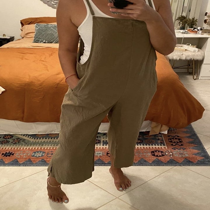 a reviewer wearing olive overalls