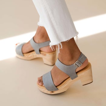 side view of a model wearing the clogs in sky grey
