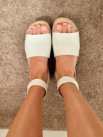 reviewer wearing the sandals in white