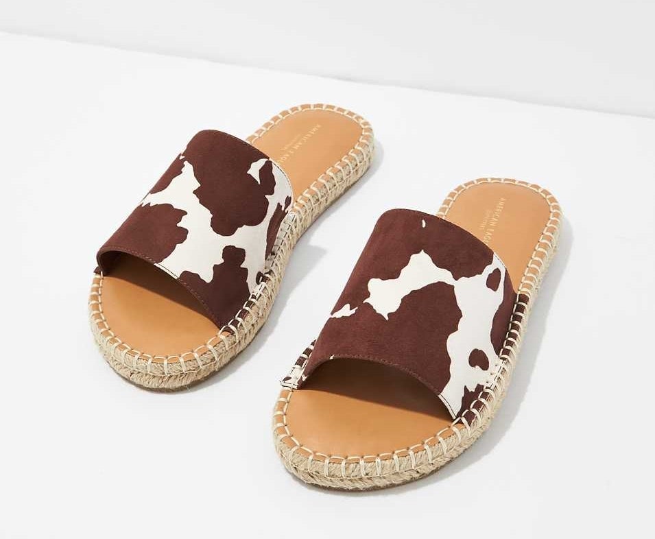 front view of the white and brown cow print espadrille sandals