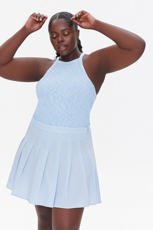 model wearing the blue plaid tennis skirt