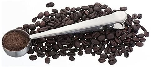 the long handled scoop on a bed of coffee beans