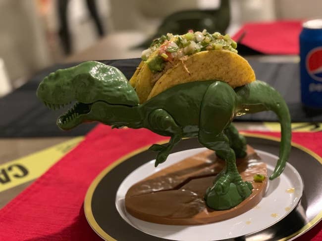 reviewer photo of a t-rex taco holder with a taco in it