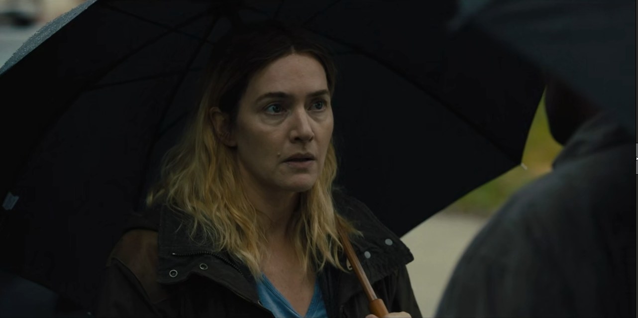 Kate Winslet under an umbrella in Mare of Easttown