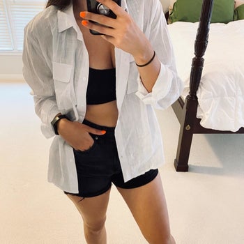 reviewer wearing the white shirt open with shorts