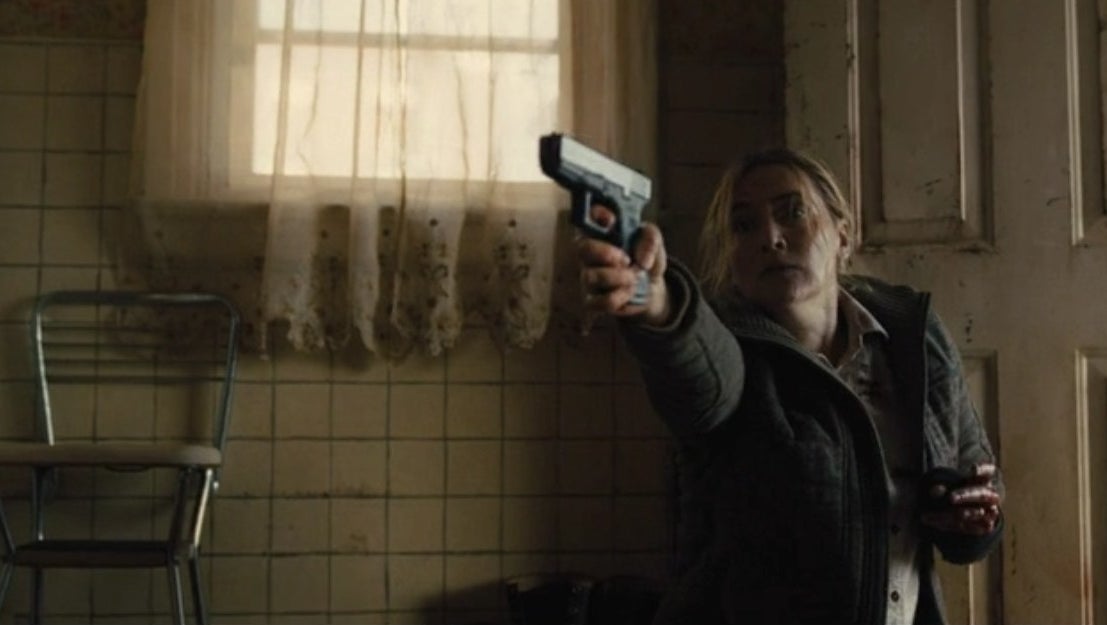 Mare (Kate Winslet) holding a gun in the miniseries