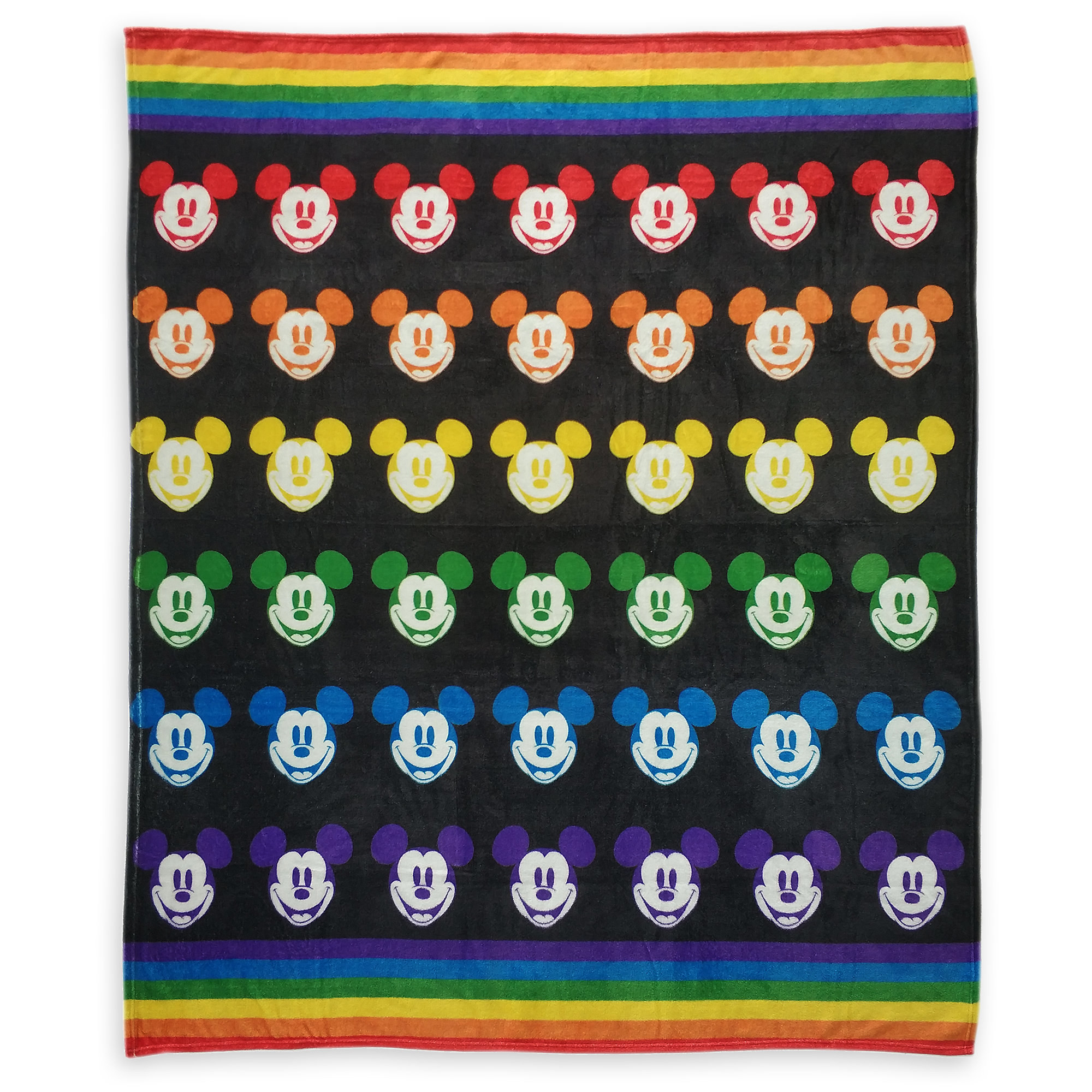 A large, soft throw blanket that has rainbow at the top and bottom and mickey&#x27;s face printed all across is in a repeating pattern