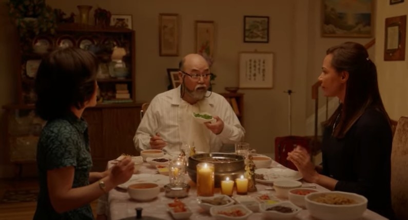 Umma, Appa, and Pastor Nina are at the Kims’ dining table about to eat dinner.