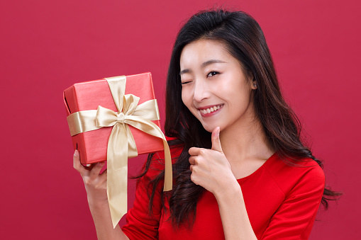 Winking woman holding gift