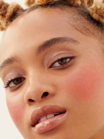 model wearing the glossier cloud paint in a light pink color