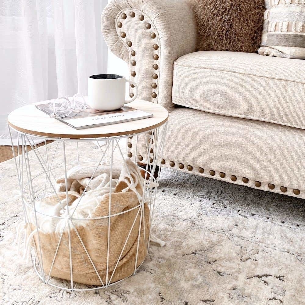 the accent table with a coffee and magazine on it