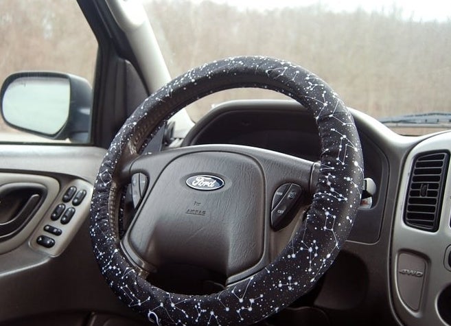 steering wheel with black cover on it that has a constellation