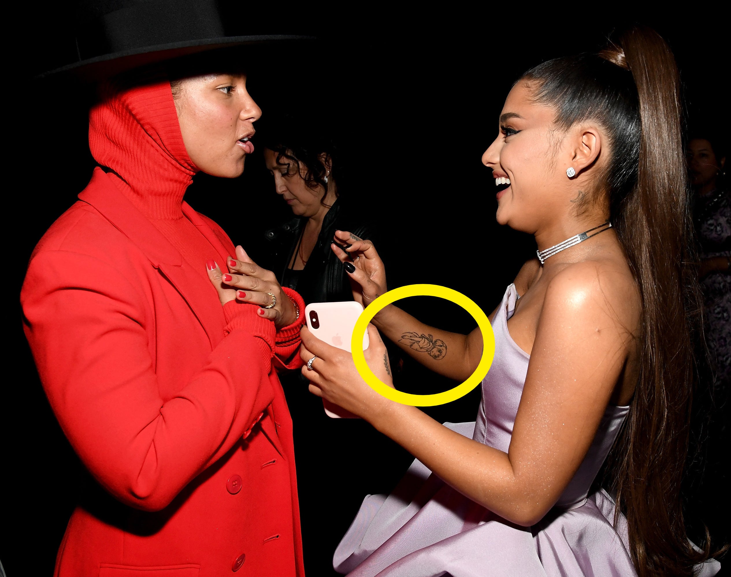 Ariana's Eevee tattoo can be seen while she holds her arm up