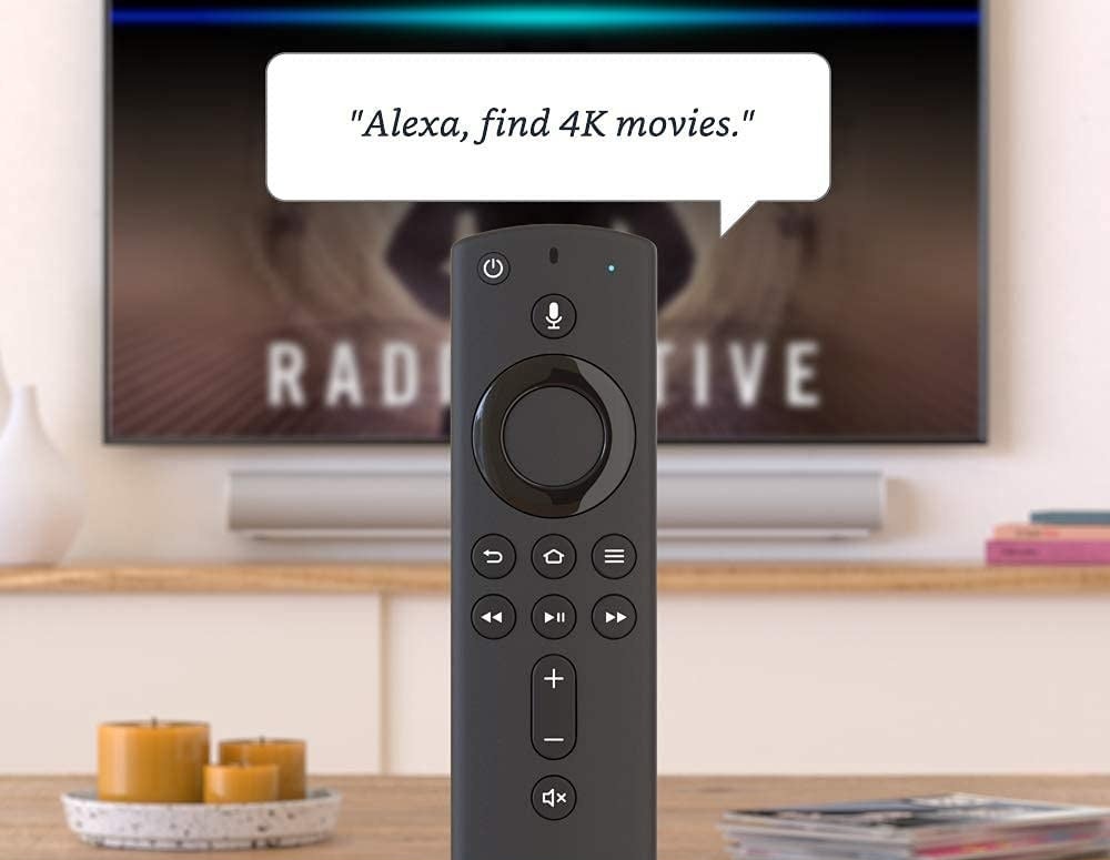 The remote in front of the TV with caption &quot;Alexa, find 4K movies&quot;