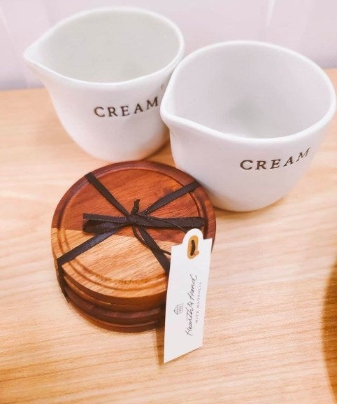 The coasters stacked next to empty &quot;cream&quot; containers