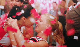 Brittany and Santana kissing as confetti falls