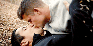 Danny and Ethan kissing on the forest ground