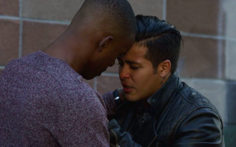 Caleb and Tony embracing and pressing their foreheads together