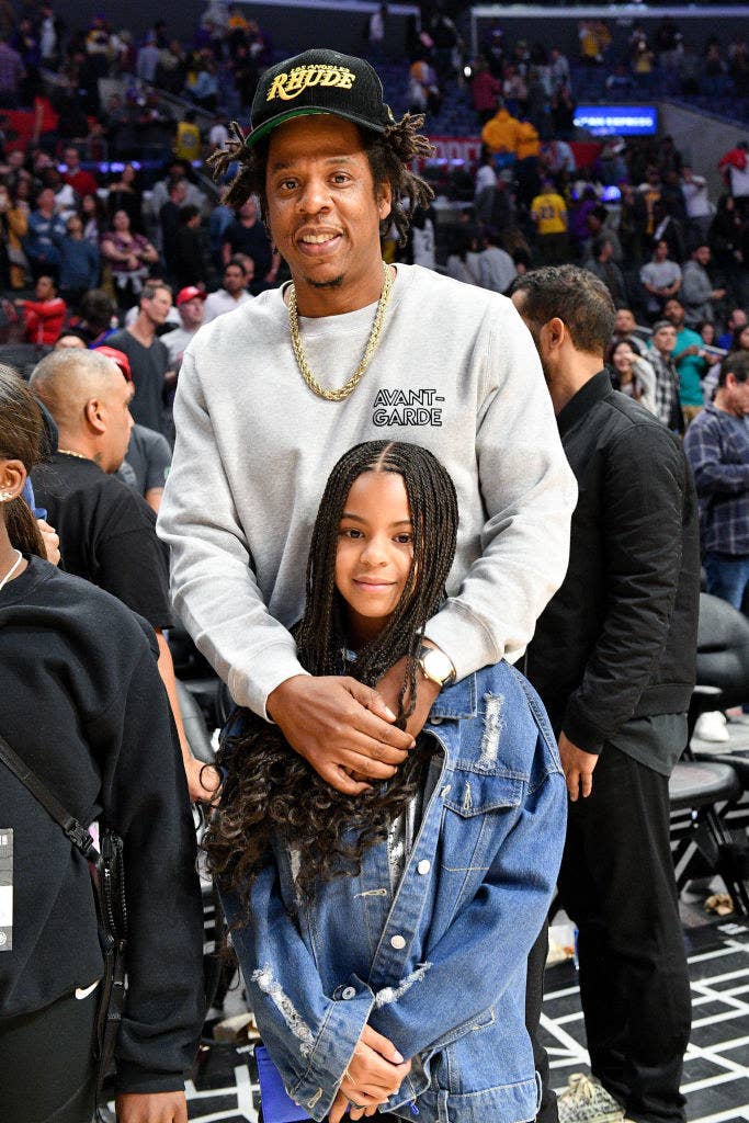 Jay-Z and Blue Ivy Carter attend a basketball game between the Los Angeles Clippers and the Los Angeles Lakers